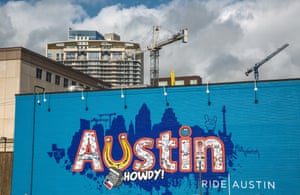 A colorful downtown wall mural sits in the shadow of new highrise construction in Austin, Texas.
