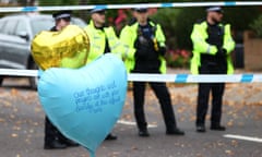 BRITAIN-POLITICS-POLICE-STABBING<br>Police officers staff a cordon as a balloon with a message from the Muslim community of Southend floats above floral tributes left at the scene of the fatal stabbing of British lawmaker David Amess, at Belfairs Methodist Church in Leigh-on-Sea, a district of Southend-on-Sea, in southeast England on October 17, 2021. - Britain's interior minister on October 17 said MPs' security would be beefed up, after a lawmaker was stabbed to death as he held a public meeting with constituents, in the second such attack in five years. (Photo by Adrian DENNIS / AFP) (Photo by ADRIAN DENNIS/AFP via Getty Images)