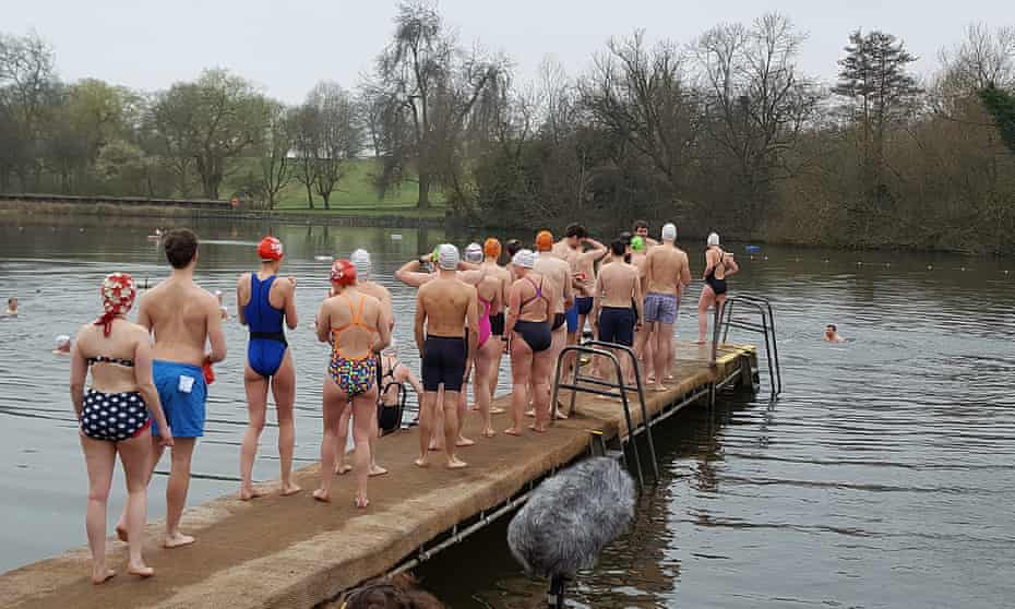Swimmers waiting to jump in Hampstead Heath's mixed bathing pond in London