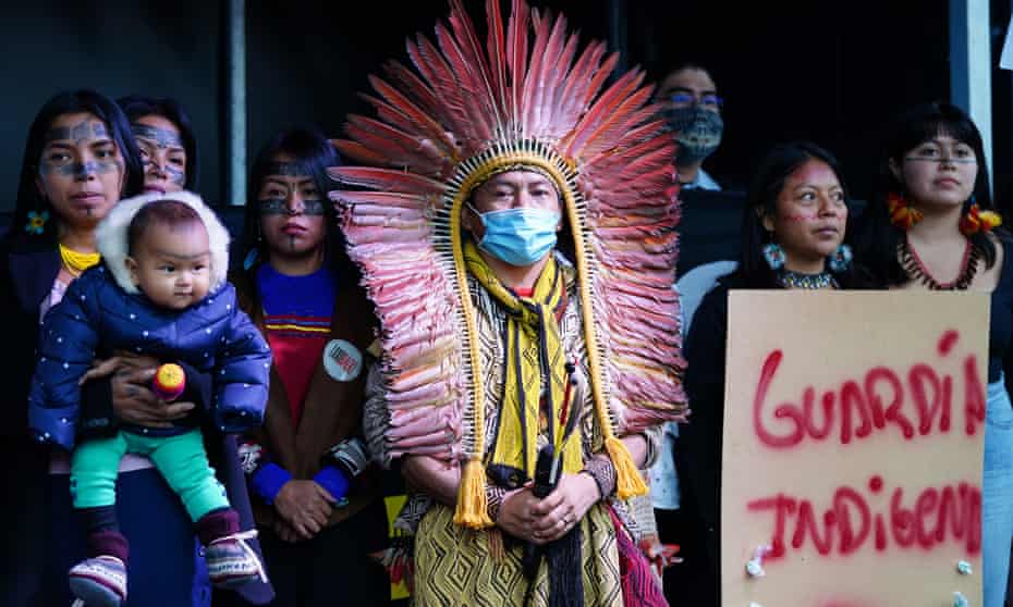 Members of indigenous groups from Brazil stand on the stage in George Square during the Cop26 summit in Glasgow.