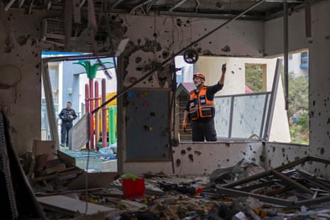 Israeli security personnel inspect the damage near Tel Aviv.