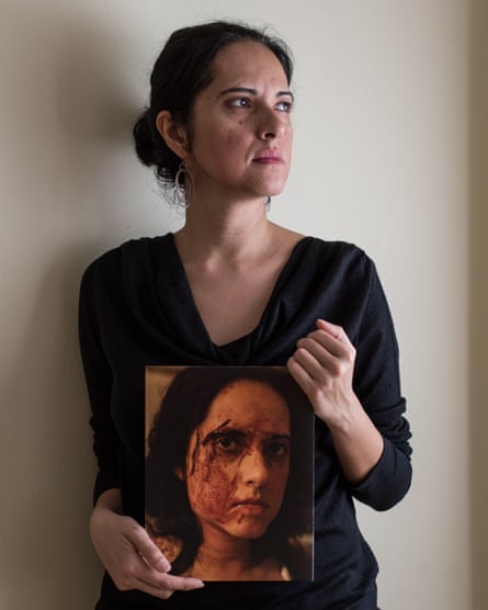 Rena Effendi holding a picture of herself taken just after she was attacked in Cairo in 2012. 