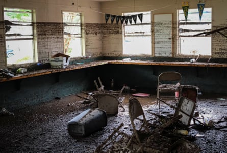 Chairs lie inside a damaged room