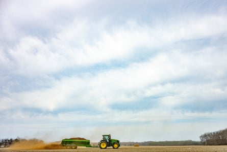 A tractor lays fertilizer connected a section astatine a farm