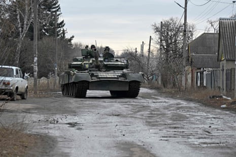 A Ukrainian tank drives through a village in Kharkiv region.
