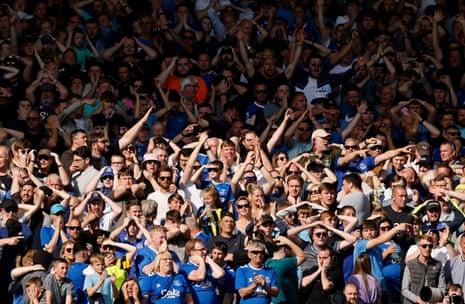 Everton fans react in the stands after hearing the Leicester score.