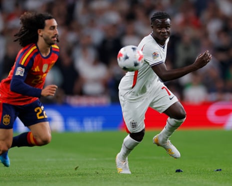 Bukayo Saka of England is pursued by Marc Cucurella