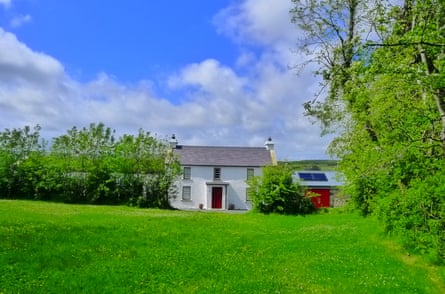 A white farmhouse set amid green fields