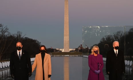 Joe Biden, his wife Jill Biden, Kamala Harris and her husband Doug Emhoff stand in front of the Washington Monument at a COVID-19 memorial event in Washington
