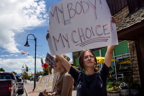 A person holds a sign that reads my body my choice