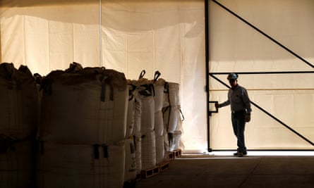 A worker closes a warehouse of lithium carbonate processed from the Rockwood Lithium mine.