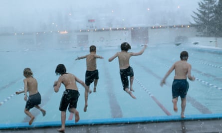 Rear view of boys jumping into a swimming pool, Reykjavik, Iceland