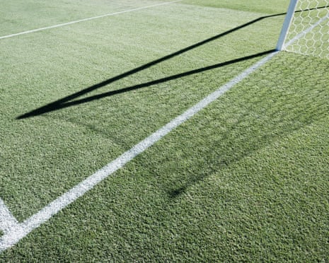 Shadow of soccer goal net on field