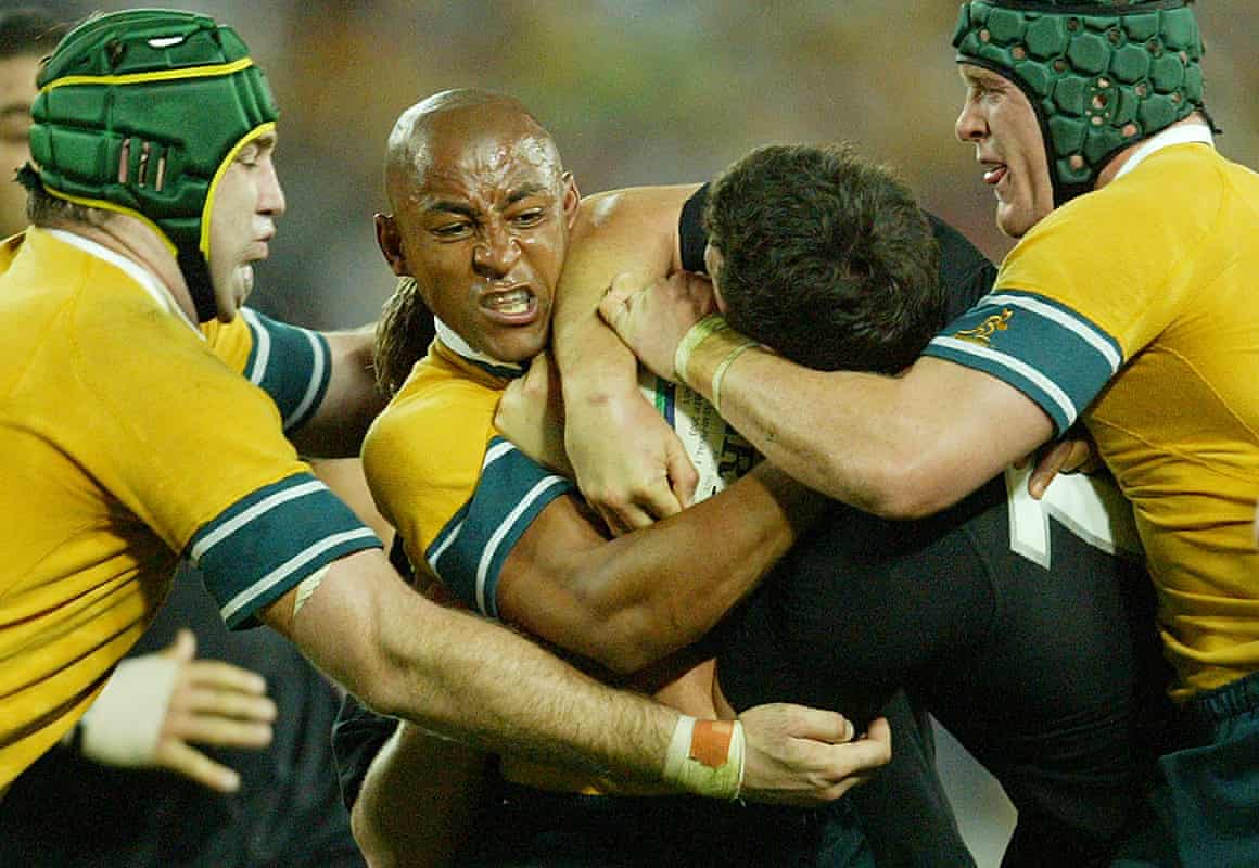 George Gregan of Australia grapples with Aaron Mauger