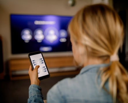 A person using a remote control app on a smartphone