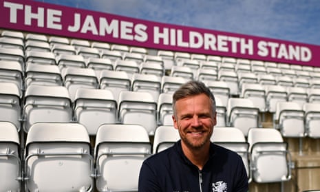 James Hildreth duduk di tribun yang dinamai menurut namanya di Taunton.
