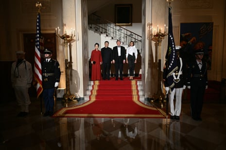 Donald and Melania Trump posed for a photograph with China’s president, Xi Jinping, and his wife, Peng Liyuan, ahead of a state dinner at the White House on Thursday. They posed near a painting Trump hung of himself raising his first after a 2024 assassination attempt in Butler, Pennsylvania.