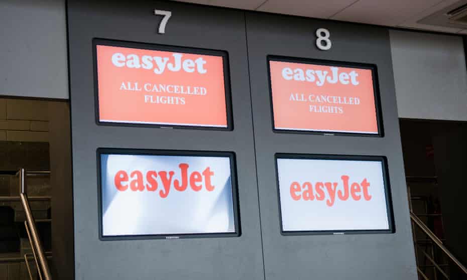 An easyjet check-in desk showing cancelled flights at Gatwick.