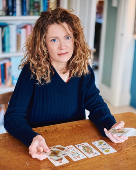Former telephone psychic sitting at a table with taror cards in front of her