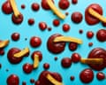 French fries and pools of ketchup in various sizes arranged on a blue surface