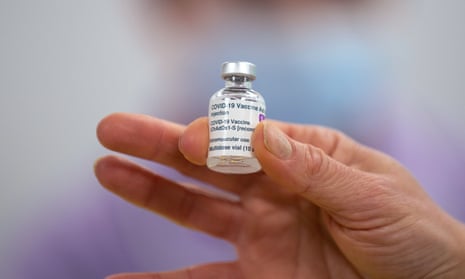 A person holds a vial of the Oxford/AstraZeneca Covid-19 vaccine.