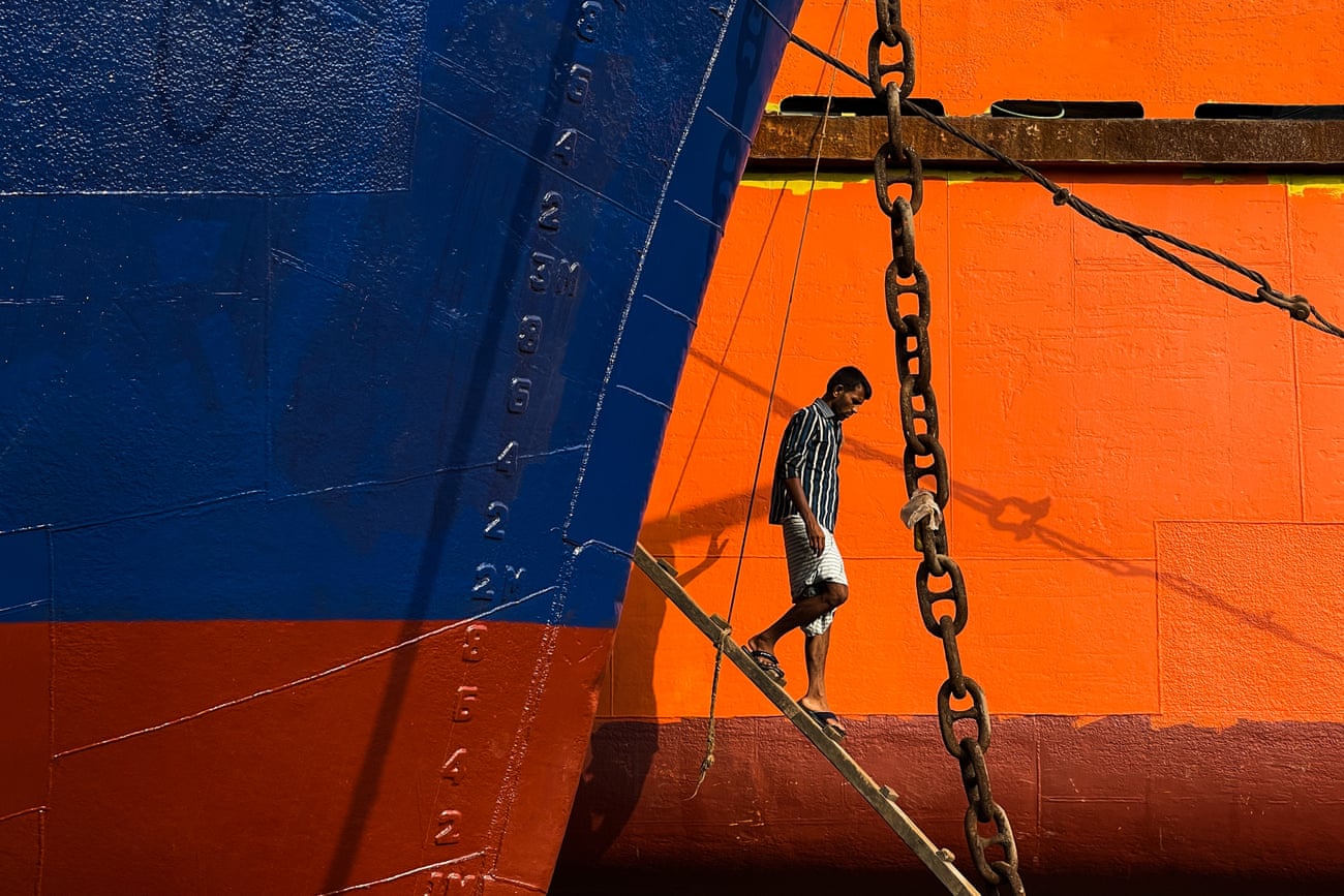 Man walking down ladder from a ship in Dhaka