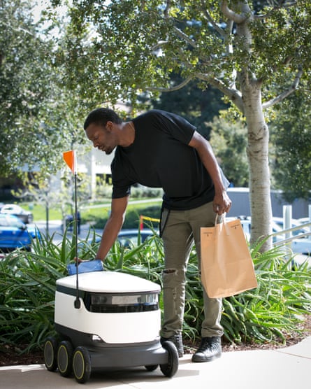 An Intuit employee gets his delivery from a Starship robot.