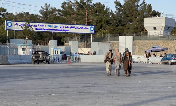Taliban stand guard at a checkpoint at Hamid Karzai airport