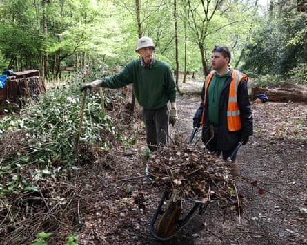 Josh Limb pushes a wheelbarrow in Hadley Wood