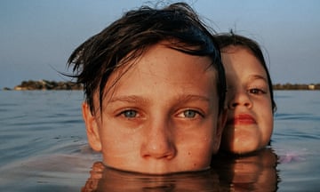 Faces of boy and girl in the sea