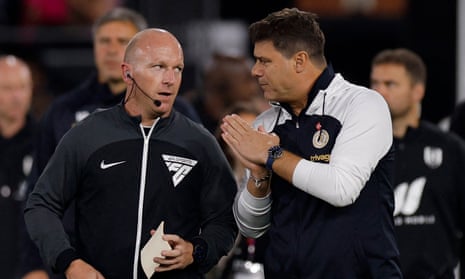 Chelsea manager Mauricio Pochettino talks to the fourth official Simon Hooper before the match against Fulham.