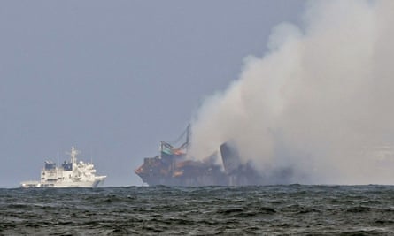 An Indian coastguard ship tries to douse the fire as smoke billows from MV X-Press Pearl