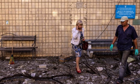 Employees at the entrance to a Mykolaiv primary care centre and family clinic destroyed by a military strike on Sunday
