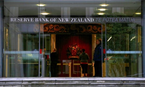 A security guard stands in the main entrance to the Reserve Bank of New Zealand in central Wellington