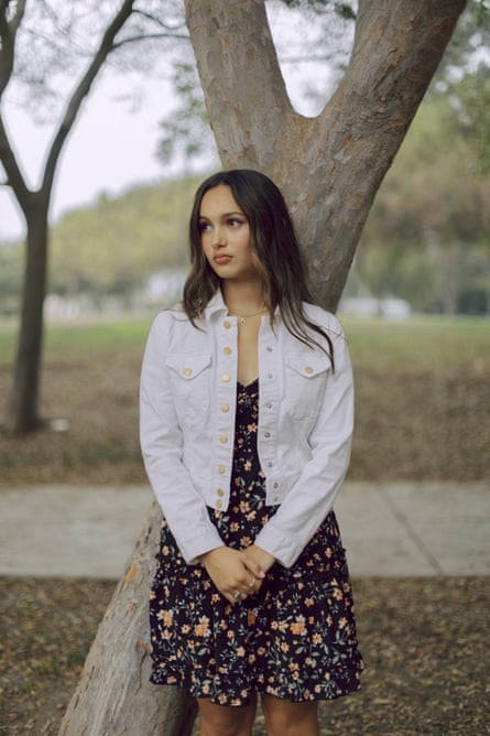 A young woman underneath a tree.