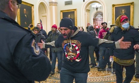 Trump supporters, including Douglas Jensen, center, confront US Capitol Police in the hallway outside of the Senate chamber at the Capitol in Washington on January 6, 2021.