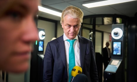Geert Wilders  in a room with media microphones in front of him