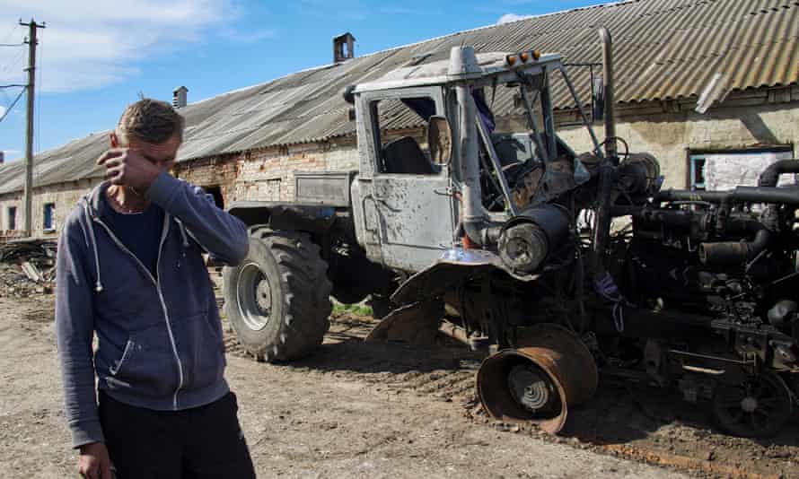 A local man with his destroyed tractor on a farm in the village of Mala Rohan, near Kharkiv.