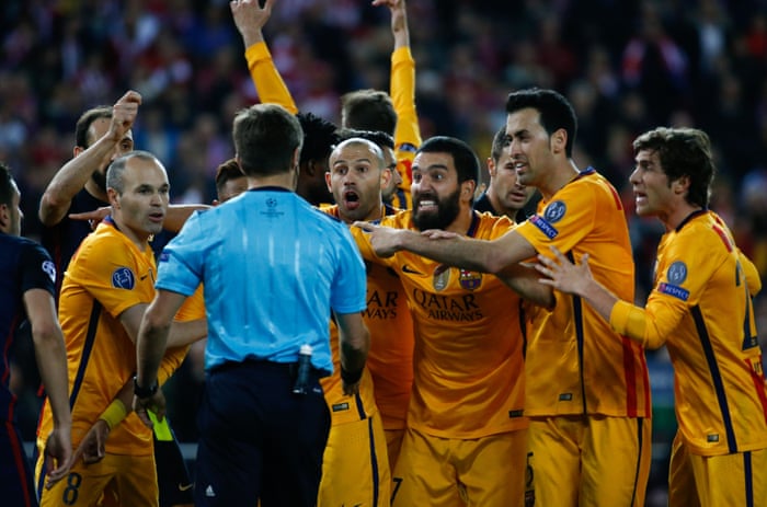 The Barcelona players attempt to change the ref's mind.