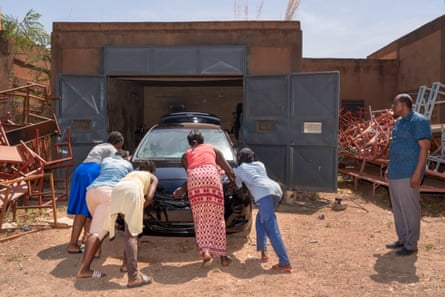 Girls working on a car