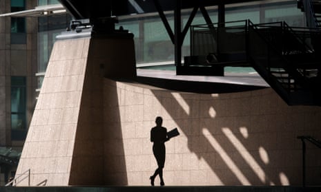 Silhouette of woman walking through the Broadgate corporate offices development in the City of London