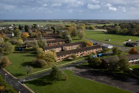 A drone view of barracks-style housing surrounded by countryside