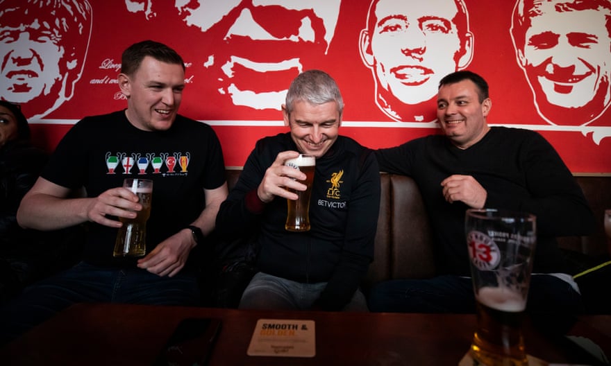 Liverpool fans Dan Wynn, Gerrard Noble and Steve Dodd enjoy a livener before the game at the Flat Iron pub.