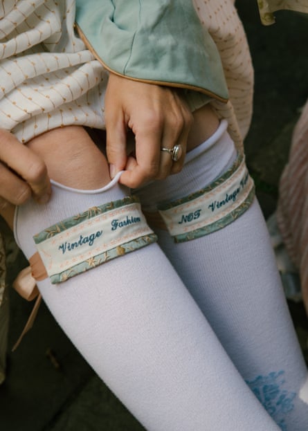 A woman shows off her handmade stockings that read ‘Vintage fashion not vintage values’