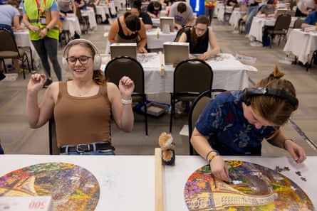 A woman putting her hands up after completing a puzzle