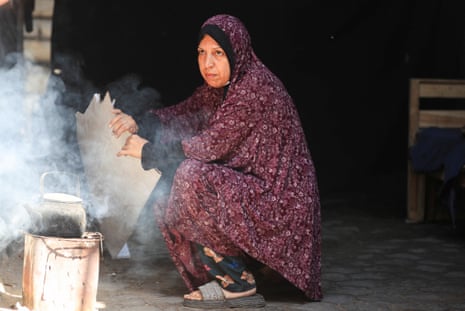 A woman cooks at a refugee camp in Gaza City.