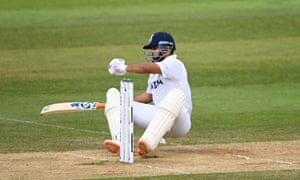 Rishabh Pant falls over after a big swing for the ball.