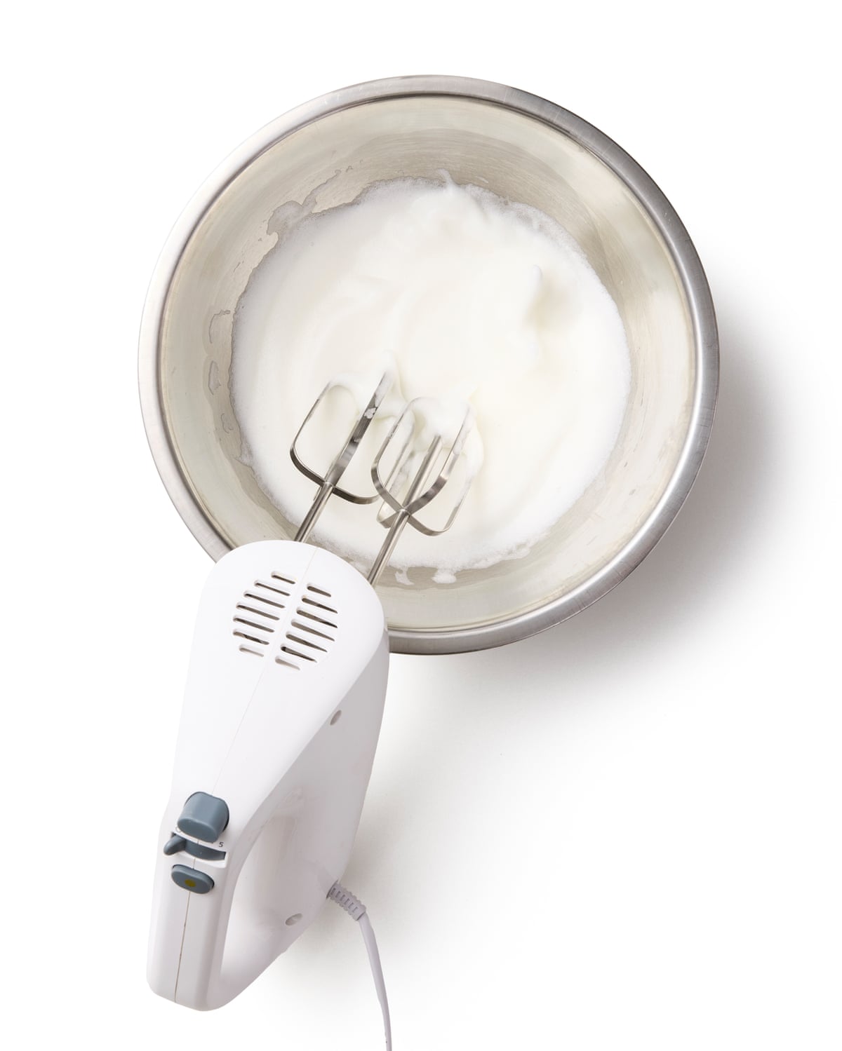 A whisk in a bowl of egg whites
