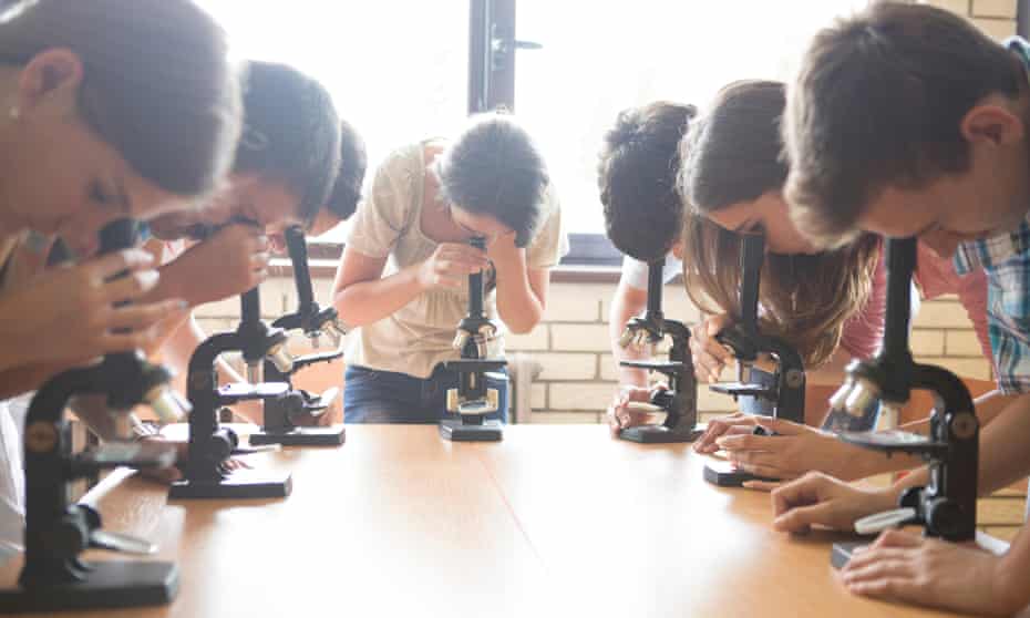 students with microscopes