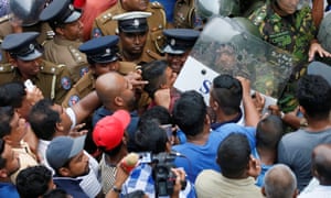 Supporters of Sri Lanka’s newly appointed prime minister Mahinda Rajapaksa are pushed by members of the Special Task Force and the police in Colombo